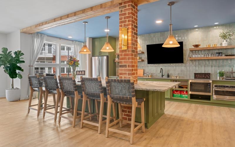 a community kitchen with a bar and chairs